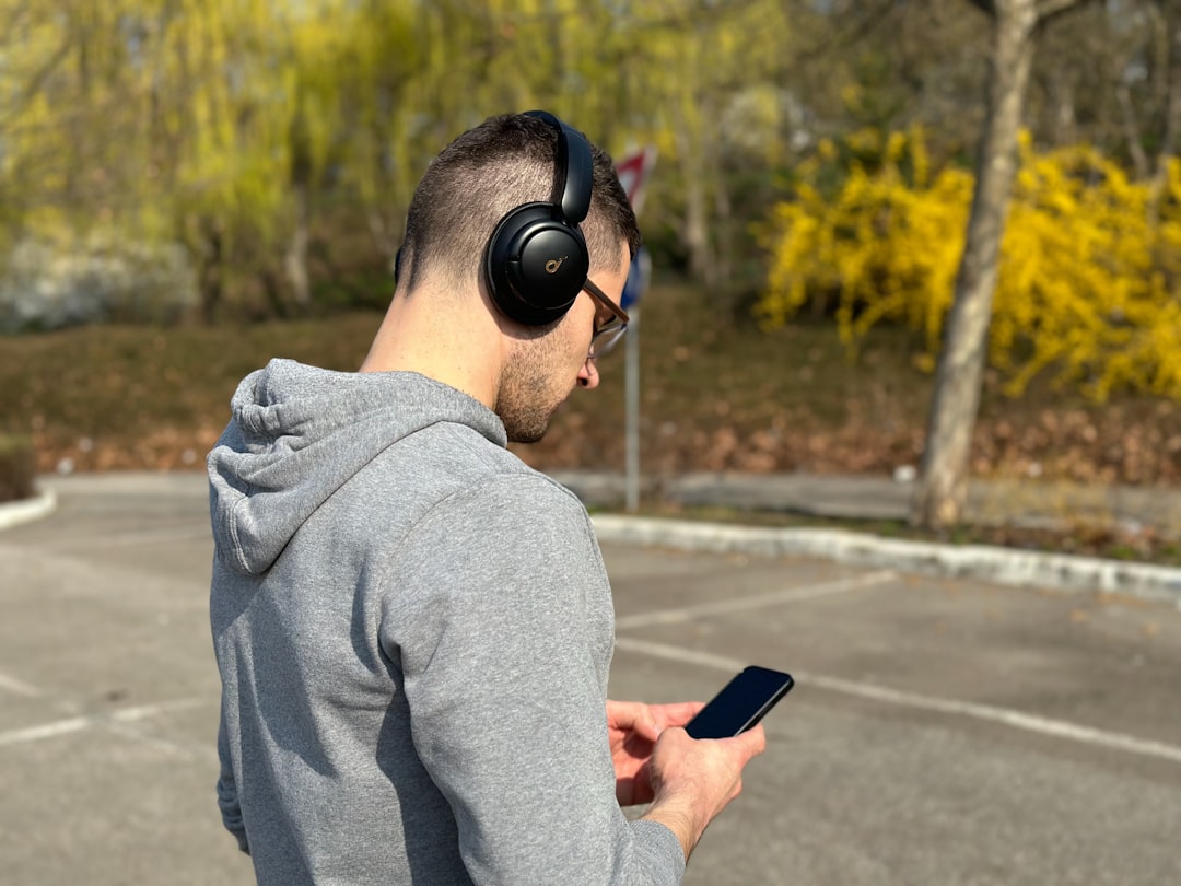 Person listening to digital audio on smartphone